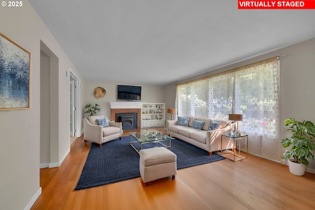 150 Maynard Ave, Eugene, OR 97404 - living area with wood finished floors, a fireplace, and baseboards