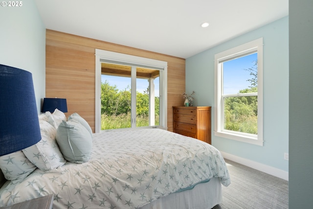 32996 Pacific Bellevue Ln, Warrenton, OR 97146 - carpeted bedroom with wood walls, baseboards, and recessed lighting