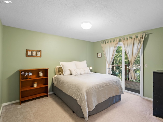 carpeted bedroom with access to exterior and a textured ceiling