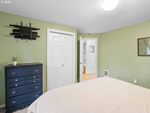 bedroom featuring a closet and a textured ceiling