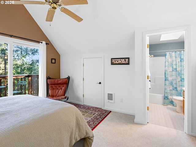 bedroom featuring connected bathroom, heating unit, vaulted ceiling, carpet floors, and ceiling fan