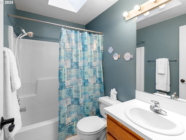 full bathroom with shower / bathtub combination with curtain, vanity, a skylight, and toilet