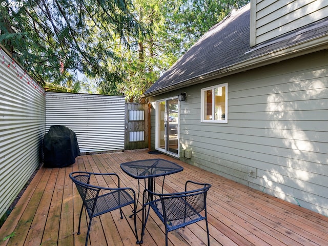 wooden deck with a grill