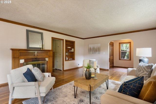 6807 SE Cesar E Chavez Blvd, Portland, OR 97202 - living room with arched walkways, light wood-style flooring, ornamental molding, baseboards, and a textured ceiling