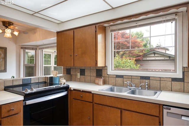 6807 SE Cesar E Chavez Blvd, Portland, OR 97202 - kitchen featuring range with electric cooktop, a sink, white dishwasher, and light countertops
