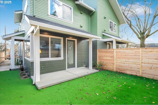 rear view of property featuring a yard and a patio