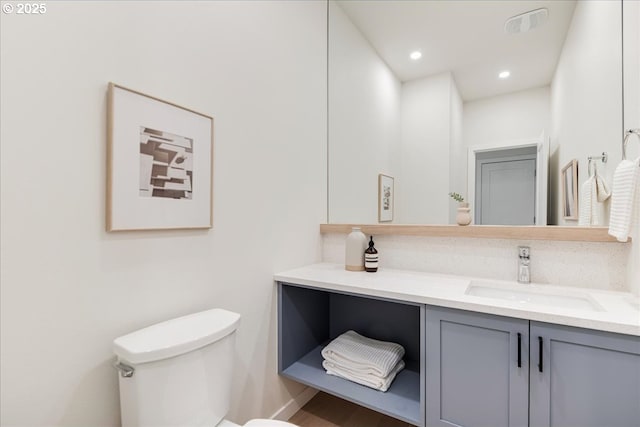 bathroom with vanity and toilet