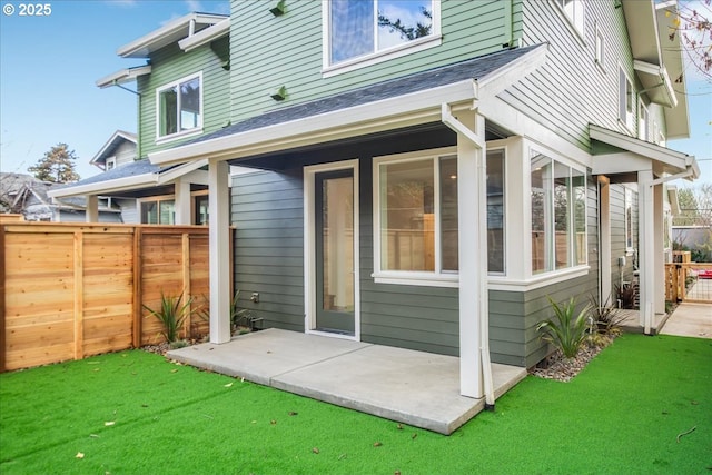 back of house with a lawn and a patio area