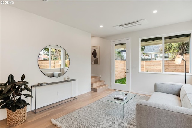 living room with light wood-type flooring and plenty of natural light