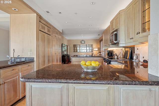 766 NW Westover Sq, Portland, OR 97210 - kitchen with stainless steel microwave, a peninsula, black electric range oven, dark stone countertops, and recessed lighting