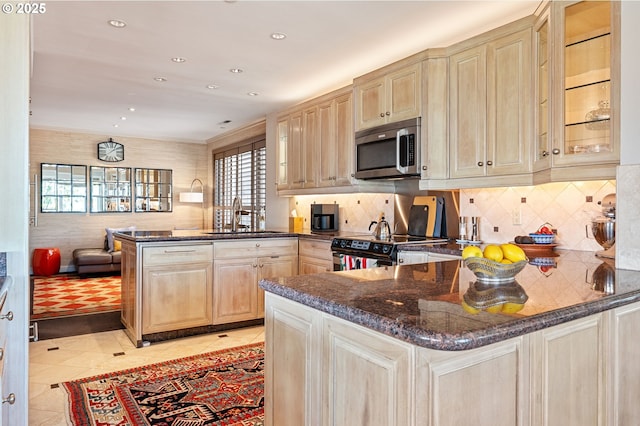 766 NW Westover Sq, Portland, OR 97210 - kitchen featuring stainless steel microwave, a peninsula, light brown cabinets, electric range, and healthy amount of natural light