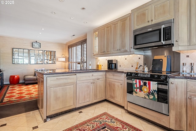 766 NW Westover Sq, Portland, OR 97210 - kitchen featuring stainless steel microwave, electric range, light tile patterned floors, a peninsula, and light brown cabinetry