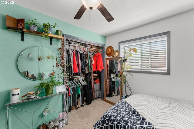 carpeted bedroom featuring a closet and a ceiling fan
