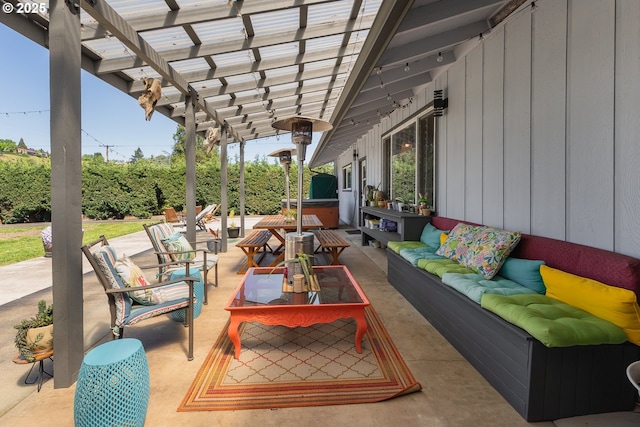 view of patio / terrace with a pergola, a hot tub, and an outdoor hangout area