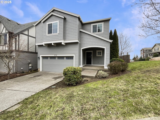 view of front of house featuring a garage, driveway, and a front lawn