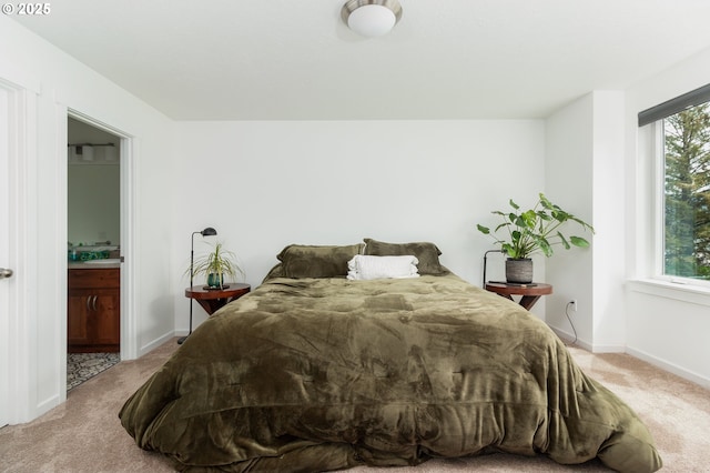 1937 NE 7th Dr, Lincoln City, OR 97367 - bedroom with carpet, baseboards, ensuite bathroom, and a sink