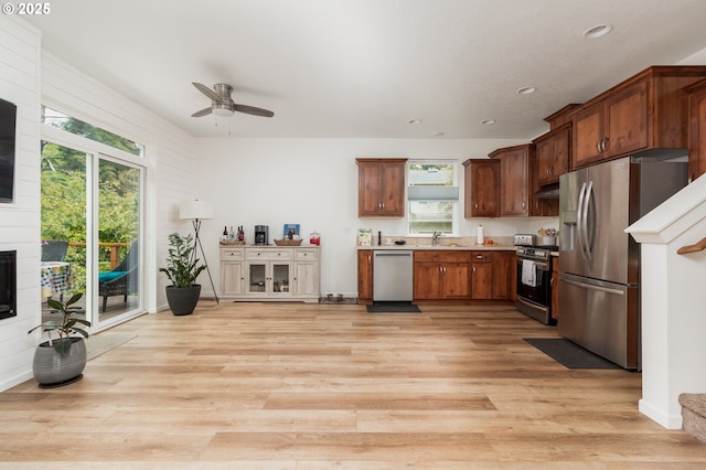1937 NE 7th Dr, Lincoln City, OR 97367 - kitchen with stainless steel appliances, a sink, ceiling fan, light wood-style floors, and light countertops