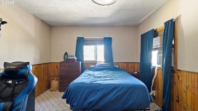 468 E Sunset Dr, Hermiston, OR 97838 - bedroom featuring wood walls, a wainscoted wall, a textured ceiling, and cooling unit