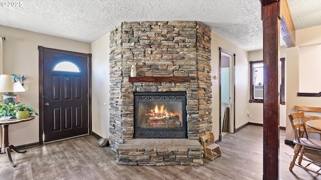 468 E Sunset Dr, Hermiston, OR 97838 - entryway featuring wood finished floors, a textured ceiling, a fireplace, and plenty of natural light