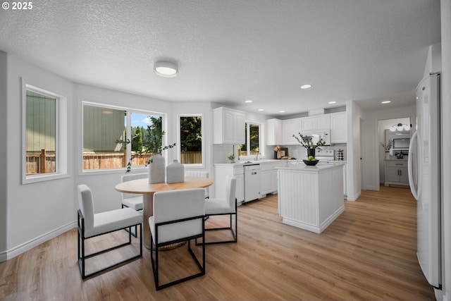 2952 NW Ogden St, Camas, WA 98607 - dining space featuring light wood-style floors, baseboards, recessed lighting, and a textured ceiling