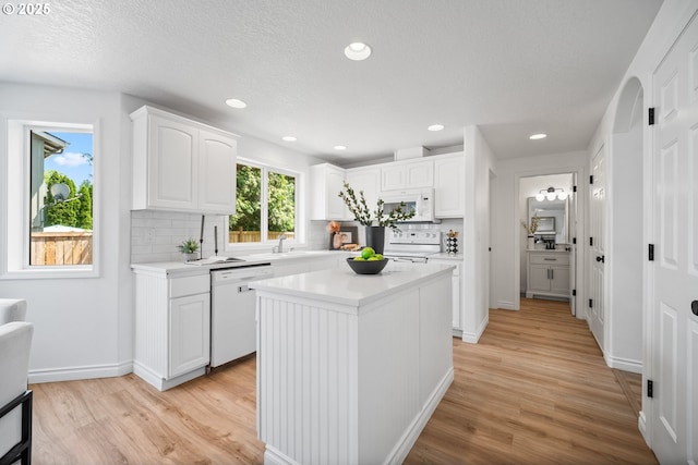 2952 NW Ogden St, Camas, WA 98607 - kitchen featuring white appliances, light countertops, decorative backsplash, light wood-type flooring, and recessed lighting