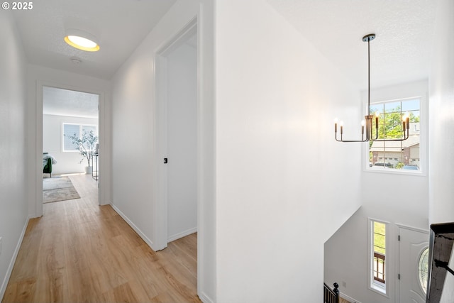 2952 NW Ogden St, Camas, WA 98607 - hallway featuring light wood-style floors, an upstairs landing, and baseboards