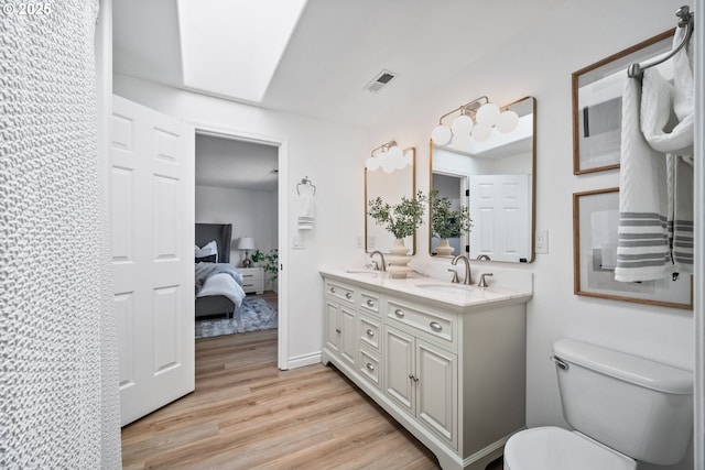 2952 NW Ogden St, Camas, WA 98607 - bathroom featuring double vanity, wood finished floors, ensuite bath, and toilet