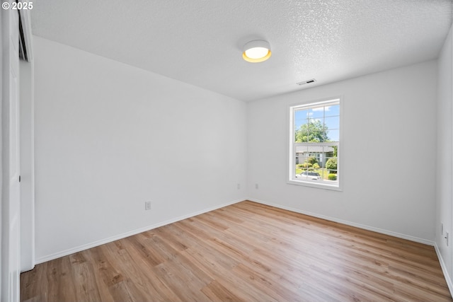 2952 NW Ogden St, Camas, WA 98607 - spare room with light wood-type flooring, baseboards, and a textured ceiling
