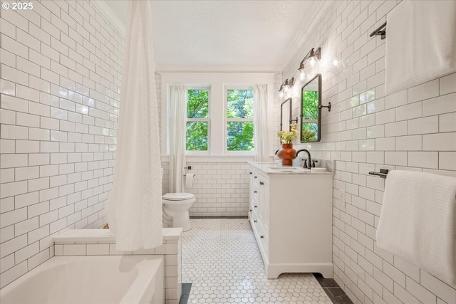 1520 SE 54th Ave, Portland, OR 97215 - bathroom featuring tile walls, crown molding, vanity, toilet, and a tub to relax in