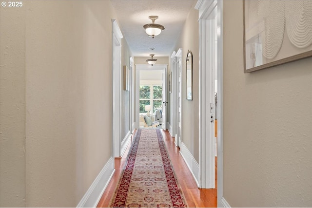 1520 SE 54th Ave, Portland, OR 97215 - hallway featuring wood finished floors and baseboards