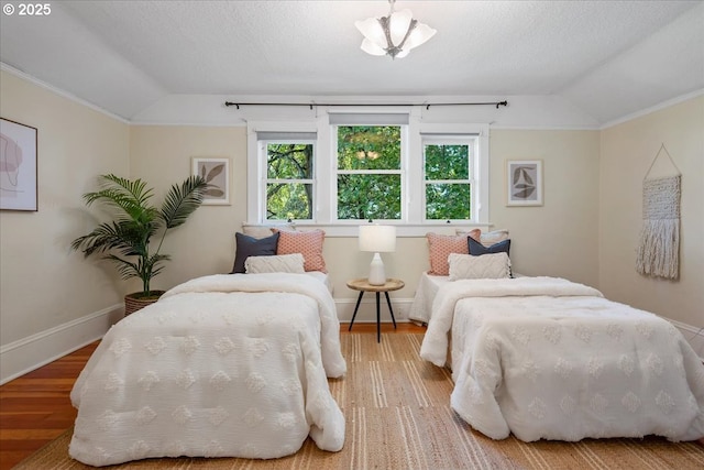 1520 SE 54th Ave, Portland, OR 97215 - bedroom featuring vaulted ceiling, multiple windows, wood finished floors, and baseboards