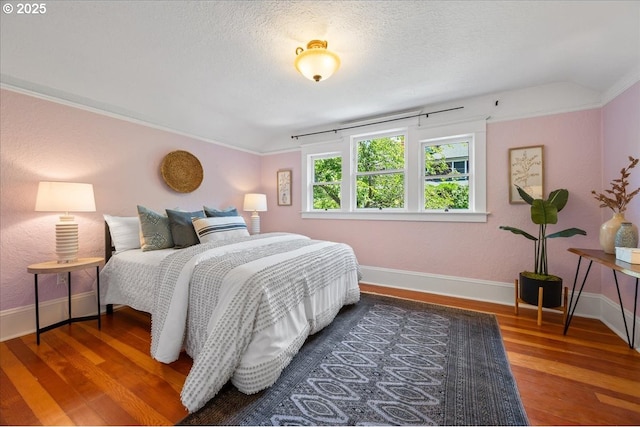 1520 SE 54th Ave, Portland, OR 97215 - bedroom with wood finished floors, baseboards, crown molding, and a textured ceiling