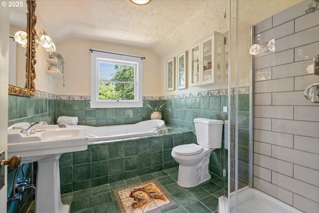 1520 SE 54th Ave, Portland, OR 97215 - full bath with tile patterned floors, tile walls, toilet, a shower stall, and a textured ceiling