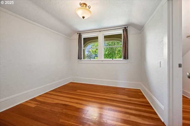 1520 SE 54th Ave, Portland, OR 97215 - bonus room with lofted ceiling, a textured ceiling, wood-type flooring, baseboards, and a textured wall