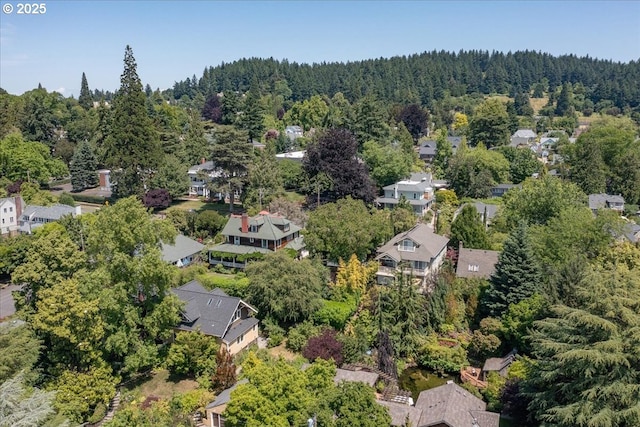 1520 SE 54th Ave, Portland, OR 97215 - aerial overview of property's location featuring a forest and nearby suburban area