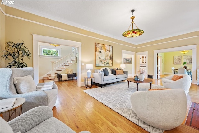 1520 SE 54th Ave, Portland, OR 97215 - living area with stairway, light wood-style floors, ornamental molding, and baseboards