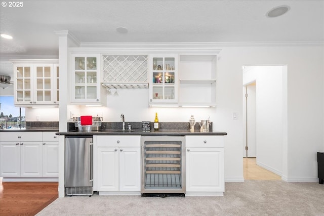 bar featuring beverage cooler, wet bar, light carpet, a sink, and crown molding