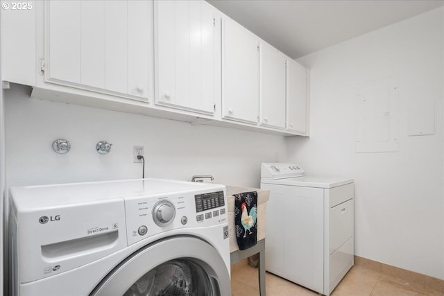 washroom with washing machine and dryer, baseboards, light tile patterned floors, and cabinet space