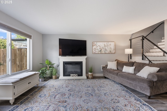 29460 SW Volley St Unit 72, Wilsonville, OR 97070 - living area with baseboards, a glass covered fireplace, wood finished floors, and stairway