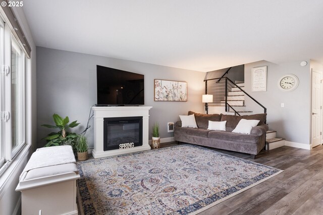 29460 SW Volley St Unit 72, Wilsonville, OR 97070 - living room with baseboards, a glass covered fireplace, wood finished floors, and stairway