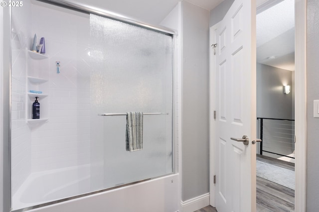 29460 SW Volley St Unit 72, Wilsonville, OR 97070 - bathroom with baseboards, shower / bath combination with glass door, and wood finished floors
