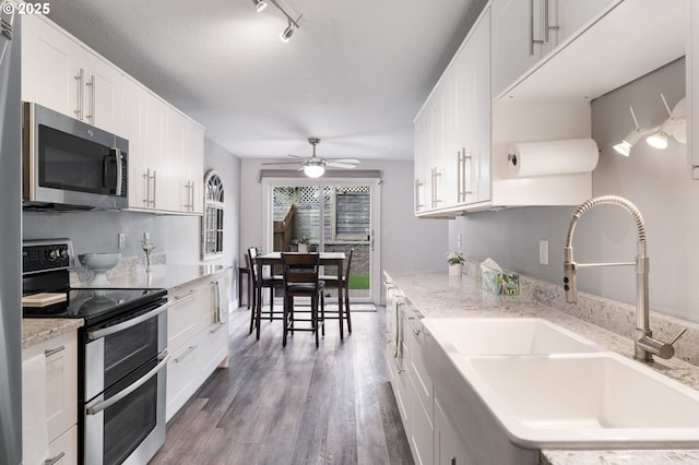 29460 SW Volley St Unit 72, Wilsonville, OR 97070 - kitchen with ceiling fan, appliances with stainless steel finishes, wood finished floors, a sink, and white cabinetry