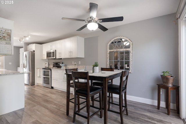 29460 SW Volley St Unit 72, Wilsonville, OR 97070 - dining space with baseboards, ceiling fan, and light wood-type flooring