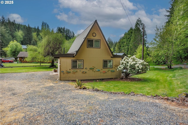 view of side of home with a lawn