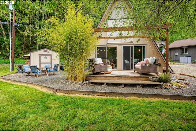 back of property with a deck, a shed, an outbuilding, and a lawn