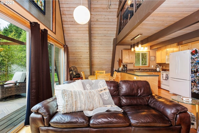 living area featuring wood walls, light wood-type flooring, and a high ceiling