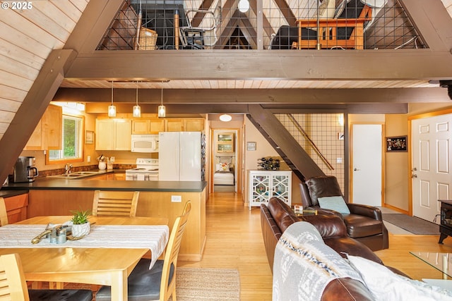 dining room featuring light wood finished floors, wooden ceiling, and beamed ceiling
