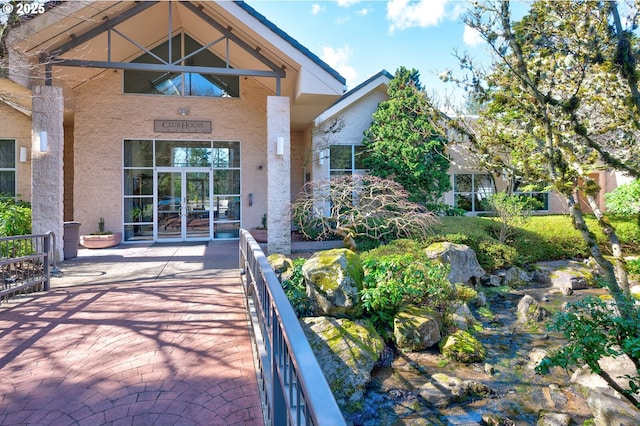 exterior space with french doors and stucco siding