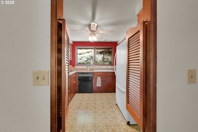 1770 W 28th Ave, Eugene, OR 97405 - kitchen with black dishwasher, ceiling fan, light countertops, brown cabinetry, and freestanding refrigerator