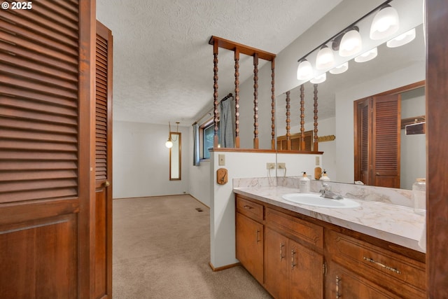1770 W 28th Ave, Eugene, OR 97405 - bathroom with a textured ceiling, vanity, and a closet